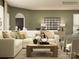 Comfortable living room with a cream colored sectional sofa, decorative pillows and coffee table decor at 2249 Moon Crest Rd, Lancaster, SC 29720