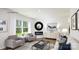Bright living room with hardwood floors, a modern fireplace, comfortable seating, and large windows at 233 Paige Rd, Kings Mountain, NC 28086