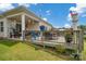 Inviting back deck, perfect for entertaining, with a covered area, outdoor dining set, and green lawn at 2473 Riparian Way, Denver, NC 28037