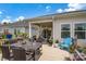 Back deck featuring a dining set, comfortable seating, and a covered area for outdoor relaxation and entertaining at 2473 Riparian Way, Denver, NC 28037