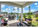 Spacious covered deck with comfortable lounge seating, dining area, and a view of the well-manicured backyard at 2473 Riparian Way, Denver, NC 28037