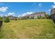 Large, well-maintained backyard with a spacious lawn, a view of the deck, and a fenced property line at 2473 Riparian Way, Denver, NC 28037