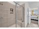 Modern tiled shower with glass door and convenient built-in shelving at 2473 Riparian Way, Denver, NC 28037
