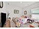 Comfortable bedroom with a floral comforter, side table, and natural light at 2473 Riparian Way, Denver, NC 28037