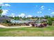 Community pool area with well-maintained landscaping, shade structures, and seating for relaxing by the poolside at 2473 Riparian Way, Denver, NC 28037
