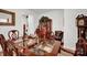 Elegant dining space with rich wood furniture, decorative accents, and ample seating at 2473 Riparian Way, Denver, NC 28037