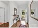 Bright entryway features hardwood floors, a stylish console table, and a decorative mirror enhancing the home's charm at 2473 Riparian Way, Denver, NC 28037