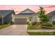 Charming home with a two-car garage, beautifully landscaped yard, and a welcoming front door with a wreath at 2473 Riparian Way, Denver, NC 28037