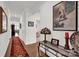 Hallway with hardwood floors, elegant decor, and a glimpse into the living spaces enhances the home's inviting atmosphere at 2473 Riparian Way, Denver, NC 28037