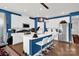 Modern kitchen with white cabinetry, stainless steel appliances, a spacious island with seating at 2473 Riparian Way, Denver, NC 28037