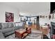 Open-concept living area with hardwood floors, a modern fireplace, and a view into the kitchen at 2473 Riparian Way, Denver, NC 28037