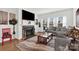 Cozy living room featuring a fireplace, large windows, and comfortable seating at 2473 Riparian Way, Denver, NC 28037