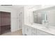 Bathroom showcasing double vanity, large mirror, modern lighting, and tiled shower with a glass enclosure at 248 Miramar Dr, York, SC 29745
