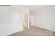 Carpeted bedroom with an open doorway, white walls, and white trim at 248 Miramar Dr, York, SC 29745