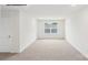 This large bedroom has neutral carpet and a big window looking out at a neighborhood at 248 Miramar Dr, York, SC 29745