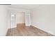Empty room with hardwood flooring and light walls, featuring double doors to another room at 248 Miramar Dr, York, SC 29745