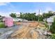 A construction site displays a foundation, materials, and equipment set against a backdrop of neighboring houses and trees at 263 Robinson St, Rock Hill, SC 29730