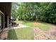 Private backyard featuring mature trees and a patio with outdoor seating at 3041 Shallowood Ln, Charlotte, NC 28277