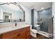 Bathroom featuring vanity, decorative mirror, and shower with blue subway tile and glass door at 3041 Shallowood Ln, Charlotte, NC 28277