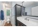 Bathroom featuring traditional fixtures, vanity, white tiling and wood flooring at 3041 Shallowood Ln, Charlotte, NC 28277