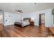Spacious bedroom featuring wood floors, ceiling fan, and ensuite bathroom access at 3041 Shallowood Ln, Charlotte, NC 28277