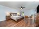 Large bedroom with wood floors, ceiling fan, and contemporary furniture at 3041 Shallowood Ln, Charlotte, NC 28277