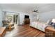Bright bedroom with wood floors, ceiling fan, and sliding glass door to the outside at 3041 Shallowood Ln, Charlotte, NC 28277