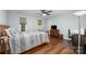 Bedroom features a ceiling fan, two windows, wood furniture, and light blue walls at 3041 Shallowood Ln, Charlotte, NC 28277