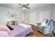 Spacious bedroom features two closets, soft blue walls, and a comfortable reading chair at 3041 Shallowood Ln, Charlotte, NC 28277