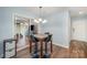 Cozy dining area with stylish lighting, modern furniture, and sliding glass doors leading to an outdoor space at 3041 Shallowood Ln, Charlotte, NC 28277