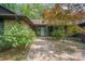 Inviting front entrance with stone walkway and decorative shrubs leading to a modern glass-paneled door at 3041 Shallowood Ln, Charlotte, NC 28277