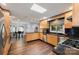 Spacious kitchen with natural wood cabinets, black countertops, and stainless steel appliances at 3041 Shallowood Ln, Charlotte, NC 28277