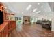 Spacious living room featuring a stone fireplace, vaulted ceilings, skylights, and a built-in bar at 3041 Shallowood Ln, Charlotte, NC 28277