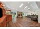 Spacious living room featuring a stone fireplace, vaulted ceilings, skylights, and a built-in bar at 3041 Shallowood Ln, Charlotte, NC 28277