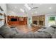 Open-concept living area featuring a stone fireplace, built-in entertainment center, and hardwood floors at 3041 Shallowood Ln, Charlotte, NC 28277