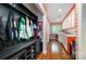 Functional mudroom with built-in storage, bench, and adjacent laundry area at 3041 Shallowood Ln, Charlotte, NC 28277