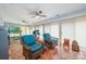 Bright sunroom with terracotta tile floors, ceiling fans, and comfortable seating at 3041 Shallowood Ln, Charlotte, NC 28277