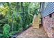 Backyard view of the wooden stairs from the side of the house, surrounded by greenery at 354 Moore Ave, Mooresville, NC 28115