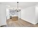 Open dining area featuring contemporary lighting, neutral walls, and modern floors at 354 Moore Ave, Mooresville, NC 28115