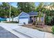 Blue house with a garage and a 'For Sale' sign on a sunny day in a residential area at 354 Moore Ave, Mooresville, NC 28115
