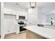 Modern, bright kitchen with stainless steel appliances, white cabinets and a quartz countertop island at 354 Moore Ave, Mooresville, NC 28115