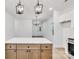 Modern kitchen with wooden cabinets, stainless steel appliances, white countertops and pendant lighting at 354 Moore Ave, Mooresville, NC 28115