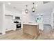 Modern kitchen with stainless steel appliances, white cabinets, and a kitchen island at 354 Moore Ave, Mooresville, NC 28115