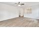 Bright, open-concept living room with neutral walls, new flooring and a ceiling fan at 354 Moore Ave, Mooresville, NC 28115