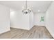 Bright living room with chandelier and entry door to patio and new vinyl flooring at 354 Moore Ave, Mooresville, NC 28115