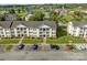 Aerial view of the apartments including parking lot and green spaces at 4024 Town Center Rd, Harrisburg, NC 28075