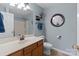 Bright bathroom with wood vanity, and updated sink, mirror and lighting at 4024 Town Center Rd, Harrisburg, NC 28075