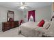 Cozy bedroom features carpeted floor, ceiling fan and large window with curtains at 4024 Town Center Rd, Harrisburg, NC 28075