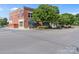A two-story brick building with a sign on the corner and covered awnings, landscaping, and parking lot at 4024 Town Center Rd, Harrisburg, NC 28075