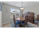 Dining room with stylish furniture and decor with natural light through the window at 4024 Town Center Rd, Harrisburg, NC 28075